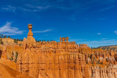 View of rock formations against blue sky