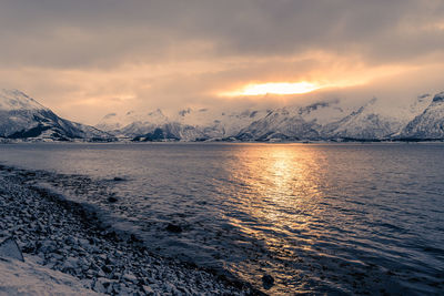 Scenic view of snowcapped mountains against sky during sunset