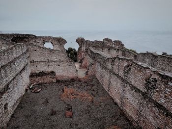 Close-up of old wall against sky