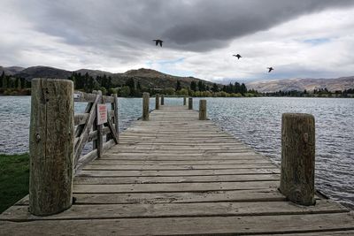 Pier over lake against sky