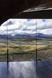 Scenic view of landscape seen through window