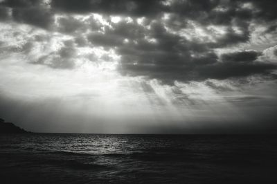 Scenic view of sea against storm clouds