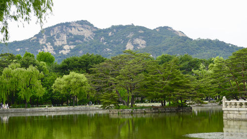 Scenic view of lake and mountains against sky