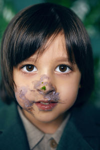 Portrait of baby boy smeared cake face