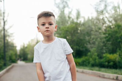 Portrait of boy standing outdoors
