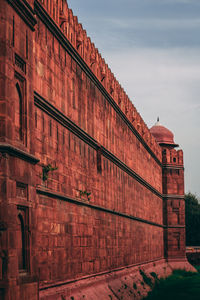 Low angle view of red building against sky