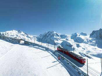 Scenic view of snowcapped mountains against clear blue sky