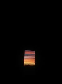 Scenic view of sunset seen through window