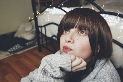 Portrait of young woman sitting outdoors