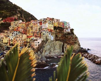 Panoramic view of sea and buildings against sky