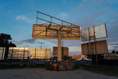 Crane at construction site against sky