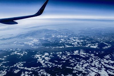 Aerial view of airplane wing over landscape