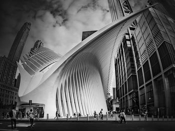 People walking on modern buildings in city against sky new york oculus 
