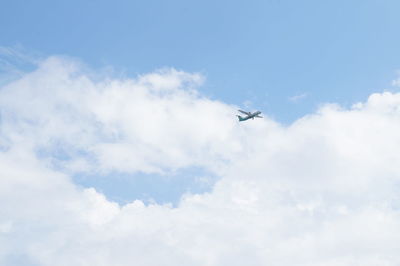 Low angle view of airplane flying in sky