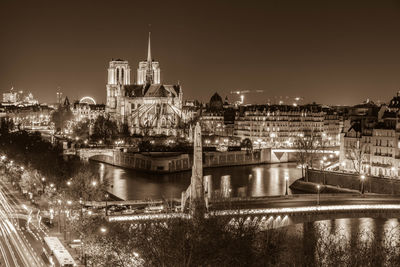 Illuminated cityscape against sky at night