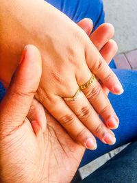 Midsection of couple holding hands