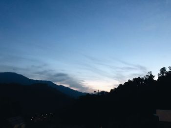 Scenic view of silhouette mountains against sky at sunset