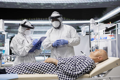 Portrait of female friends standing in laboratory