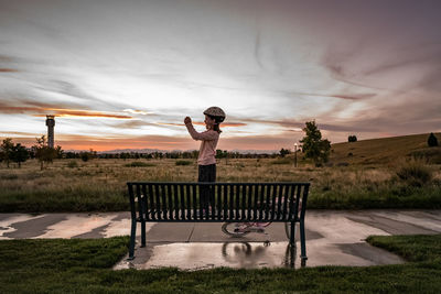 Young girl holds a camera to take a photo in a neighborhood park