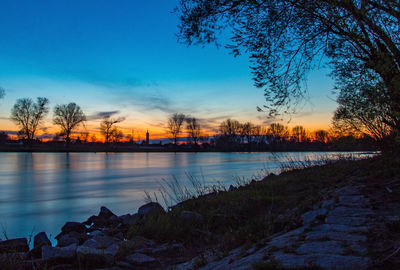 Scenic view of lake against sky during sunset