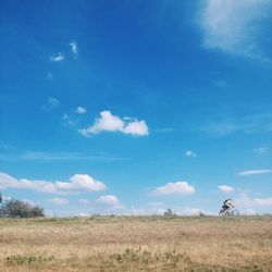 Scenic view of grassy field against cloudy sky