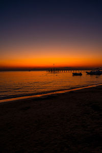 Scenic view of sea against orange sky