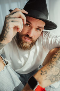 Close-up portrait of young man with tattoos