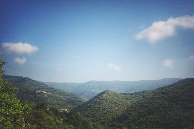 Scenic view of mountains against cloudy sky