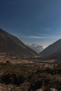 Scenic view of mountains valley against bright blue  sky at morning 