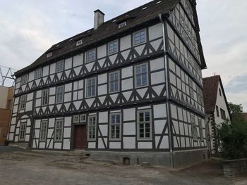 Low angle view of abandoned building against sky