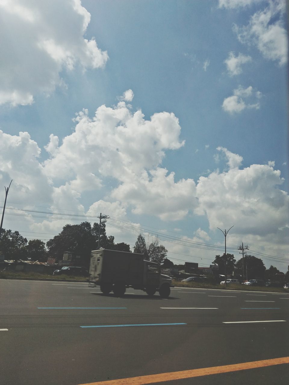 road, sky, cloud - sky, street, transportation, car, city, land vehicle, no people, tree, architecture, outdoors, built structure, day