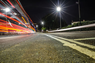 Illuminated light trails on road at night