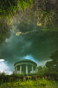 Built structure by trees against sky