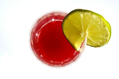 Close-up of red fruit over white background