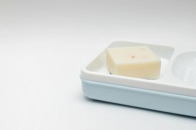 High angle view of bread in plate against white background