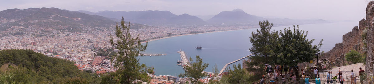 Panoramic view of trees and mountains against sky