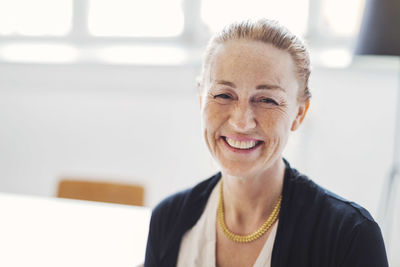 Portrait of smiling mature businesswoman in office