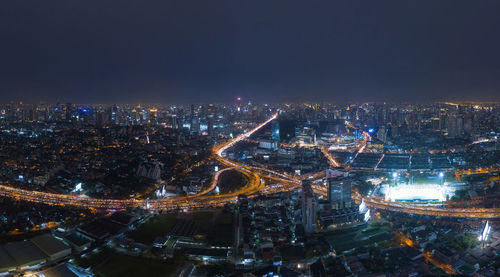 High angle view of illuminated city buildings at night