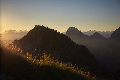 Scenic view of silhouette mountains against sky during sunset