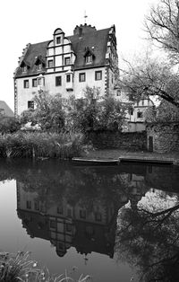 Reflection of houses and trees in water