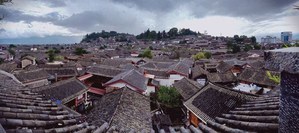 Cityscape against cloudy sky