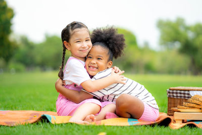 Portrait of a smiling girl sitting on grass