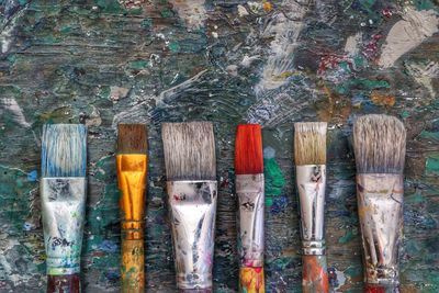 Close-up of paintbrushes arranged on table