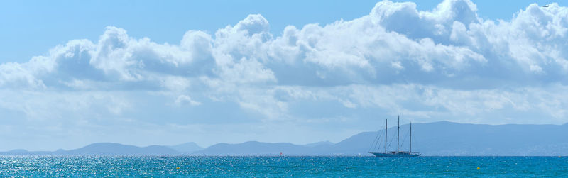 Panoramic view of sailboat in sea against sky