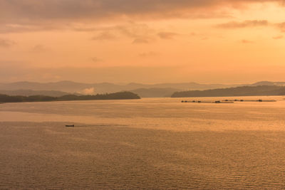 Scenic view of lake against sky during sunrise