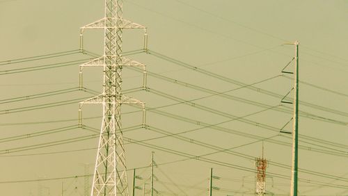 Low angle view of electricity pylon against sky