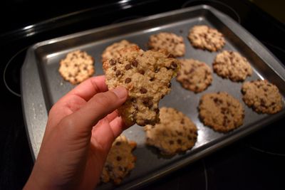 Oatmeal chocolate chip cookie in hand