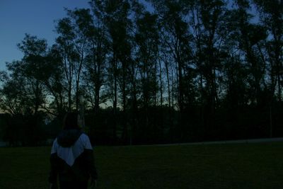 People walking on grassy field