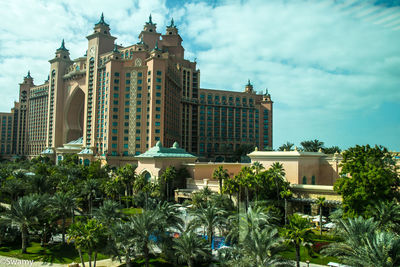 Low angle view of buildings against cloudy sky