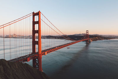 View of golden gate bridge over sea against sky during sunset